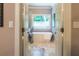 Spa-like bathroom featuring a soaking tub and marble floors at 1165 E Beechwood Nw Dr, Atlanta, GA 30327