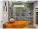 Modern bathroom features unique sink, wood counter, tile wall, and overhead shower at 1165 E Beechwood Nw Dr, Atlanta, GA 30327