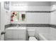 Well-lit bathroom featuring a combination tub and shower with mosaic tile accents at 1165 E Beechwood Nw Dr, Atlanta, GA 30327