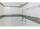 Clean bathroom features a bathtub and a glass shower wall at 1165 E Beechwood Nw Dr, Atlanta, GA 30327