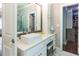 Bright bathroom with a vessel sink, white cabinets, and views of the walk-in closet at 1165 E Beechwood Nw Dr, Atlanta, GA 30327