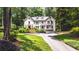 Stunning two-story home with lush landscaping, manicured lawn, and inviting driveway at 1165 E Beechwood Nw Dr, Atlanta, GA 30327