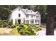 Charming two-story home with a well-manicured front yard and a variety of trees at 1165 E Beechwood Nw Dr, Atlanta, GA 30327