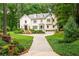 Stately home with lush landscaping, a brick driveway, and multiple dormer windows at 1165 E Beechwood Nw Dr, Atlanta, GA 30327