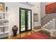 Elegant foyer features decorative glass front doors, hardwood floors, and staircase with iron railing at 1165 E Beechwood Nw Dr, Atlanta, GA 30327