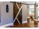 Stylish hallway featuring a modern barn door and hardwood floors at 1165 E Beechwood Nw Dr, Atlanta, GA 30327