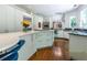 Modern kitchen with white cabinets, quartz countertops, stainless steel appliances, and island seating at 1165 E Beechwood Nw Dr, Atlanta, GA 30327