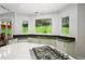 Spacious kitchen featuring granite countertops, sleek appliances, and a central island with a gas cooktop at 1165 E Beechwood Nw Dr, Atlanta, GA 30327