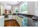 Bright kitchen with green cabinets, stainless appliances, granite countertops and a view at 1165 E Beechwood Nw Dr, Atlanta, GA 30327