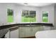 Bright kitchen featuring black granite countertops, stainless steel appliances and a lovely view from the window at 1165 E Beechwood Nw Dr, Atlanta, GA 30327