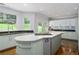 Modern kitchen featuring sleek cabinetry, granite countertops, and a center island with cooktop at 1165 E Beechwood Nw Dr, Atlanta, GA 30327