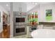 Kitchen with stainless steel appliances, and granite countertops, complemented by ample natural light from the large window at 1165 E Beechwood Nw Dr, Atlanta, GA 30327