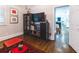 The cozy living area features a dark bookshelf, tv, and stylish decor on a hardwood floor at 1165 E Beechwood Nw Dr, Atlanta, GA 30327
