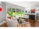 Open living area with glass doors to backyard, hardwood floors, and modern decor at 1165 E Beechwood Nw Dr, Atlanta, GA 30327