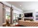 Bright living room featuring a stone fireplace, hardwood floors, and large windows at 1165 E Beechwood Nw Dr, Atlanta, GA 30327