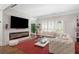 Bright living room features a modern fireplace, neutral tones, and hardwood floors at 1165 E Beechwood Nw Dr, Atlanta, GA 30327