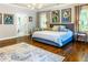 Expansive main bedroom with hardwood floors, art, a sitting area, and ensuite bathroom access at 1165 E Beechwood Nw Dr, Atlanta, GA 30327