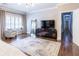 Open and airy main bedroom featuring hardwood floors, an accent chair, and large windows at 1165 E Beechwood Nw Dr, Atlanta, GA 30327