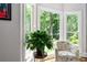 Cozy sitting area with a patterned chair and a large window overlooking a lush, green landscape at 1165 E Beechwood Nw Dr, Atlanta, GA 30327