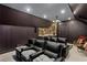 Home theater room with reclining seats, a projector, and a wet bar at 1165 E Beechwood Nw Dr, Atlanta, GA 30327