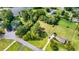 Aerial view showcasing large property with mature trees, pond and serene setting in a lovely neighborhood at 175 Heritage Farm Ln, Fayetteville, GA 30215