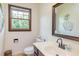 Well-lit bathroom with a sleek vanity, modern faucet, and stylish mirror at 175 Heritage Farm Ln, Fayetteville, GA 30215