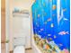 Bathroom featuring a blue shower curtain, toilet, and towel rack at 175 Heritage Farm Ln, Fayetteville, GA 30215
