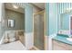 Bathroom with striped wallpaper, tile flooring, bathtub, shower and light green countertop with sink at 175 Heritage Farm Ln, Fayetteville, GA 30215