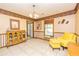 Inviting dining room with tile flooring, decorative cabinet, and comfortable yellow armchair at 175 Heritage Farm Ln, Fayetteville, GA 30215