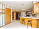 Traditional kitchen with wooden cabinets, an island with stools, and contrasting black appliances at 175 Heritage Farm Ln, Fayetteville, GA 30215