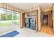 Bright laundry area equipped with a pair of washing machines and sliding door to the backyard at 175 Heritage Farm Ln, Fayetteville, GA 30215