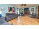 Spacious living room with hardwood floors, a brick fireplace, and modern furnishings at 175 Heritage Farm Ln, Fayetteville, GA 30215