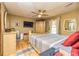 Cozy main bedroom featuring a ceiling fan, hardwood floors, and a comfortable bed at 175 Heritage Farm Ln, Fayetteville, GA 30215