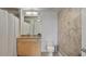 Well-lit bathroom with granite countertop vanity and a shower with white curtains at 3324 Peachtree Rd # 2717, Atlanta, GA 30326