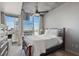 Bedroom with floor-to-ceiling windows offering city views, ceiling fan, and a comfortable queen-sized bed at 3324 Peachtree Rd # 2717, Atlanta, GA 30326