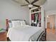 Cozy bedroom with ceiling fan, an organized closet, and an ensuite bathroom with a granite vanity at 3324 Peachtree Rd # 2717, Atlanta, GA 30326