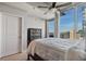 Bedroom featuring a large window with a city view, ceiling fan, and a comfortable queen-sized bed at 3324 Peachtree Rd # 2717, Atlanta, GA 30326