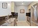 Galley kitchen featuring black backsplash, stainless steel appliances, and wood floors at 3324 Peachtree Rd # 2717, Atlanta, GA 30326
