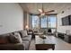 Bright living room featuring neutral decor, ceiling fan, and balcony access at 3324 Peachtree Rd # 2717, Atlanta, GA 30326