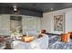 Modern lounge area featuring curved sofas, orange accents, and contemporary art at 3324 Peachtree Rd # 2717, Atlanta, GA 30326