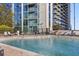 Enjoy the pool with water features and lounge seating near a high rise building at 3324 Peachtree Rd # 2717, Atlanta, GA 30326