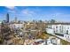 Stunning aerial view capturing the vibrant cityscape, showcasing the home's rooftop deck with a dining area at 522 Boulevard Ne Pl, Atlanta, GA 30308