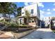 Modern two-story home featuring a unique architectural design, landscaped front yard, and a concrete driveway at 522 Boulevard Ne Pl, Atlanta, GA 30308