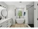 Bright bathroom with double sinks, a soaking tub, and modern fixtures offering a spa-like experience at 63 Fulton Se St, Atlanta, GA 30312