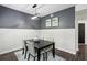 Cozy dining area with a black table, neutral chairs, and modern light fixture, next to entrance at 63 Fulton Se St, Atlanta, GA 30312