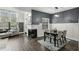 Dining area with a fireplace, wainscoting, and hardwood floors next to the living area at 63 Fulton Se St, Atlanta, GA 30312