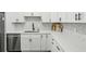 Bright and modern kitchen with white cabinets, stainless steel appliances, and stylish backsplash at 63 Fulton Se St, Atlanta, GA 30312