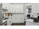Modern kitchen with white cabinets, sleek countertops, stainless steel appliances, and backsplash at 63 Fulton Se St, Atlanta, GA 30312