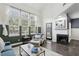 Bright living room with high ceilings, large windows, and a cozy fireplace, perfect for relaxing and entertaining guests at 63 Fulton Se St, Atlanta, GA 30312