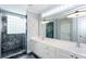 Modern bathroom features a double vanity, marble countertop, decorative lighting, and a glass-enclosed shower at 148 Murray Hill Ne Ave, Atlanta, GA 30317